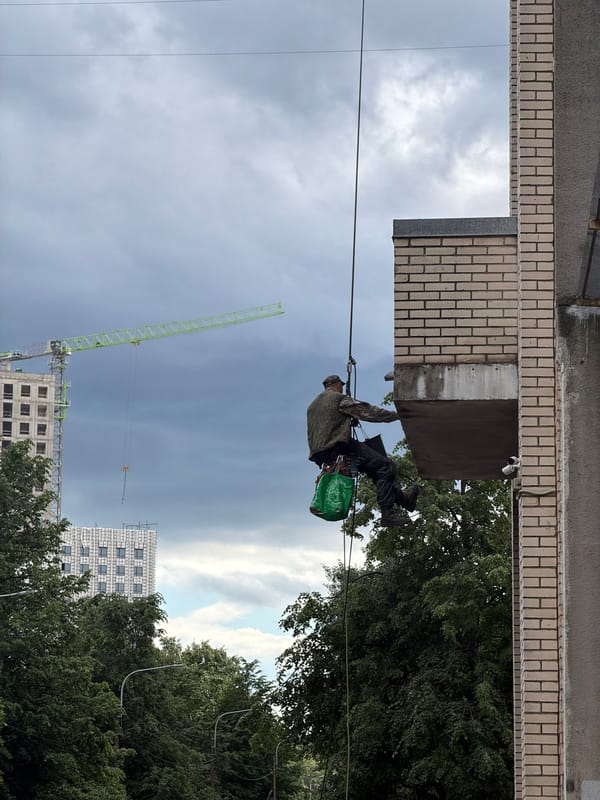 Rappelling down Saint Petersburg apartment building during morning rain
