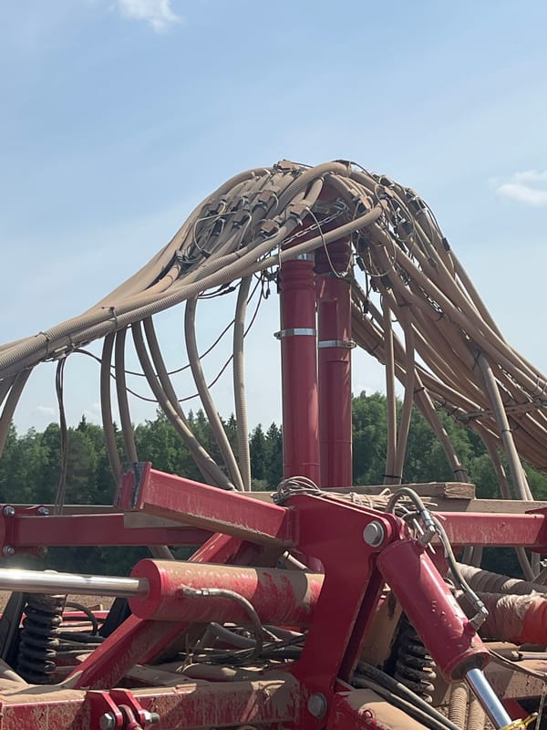 Spring planting operations documented with tractor and seeding equipment