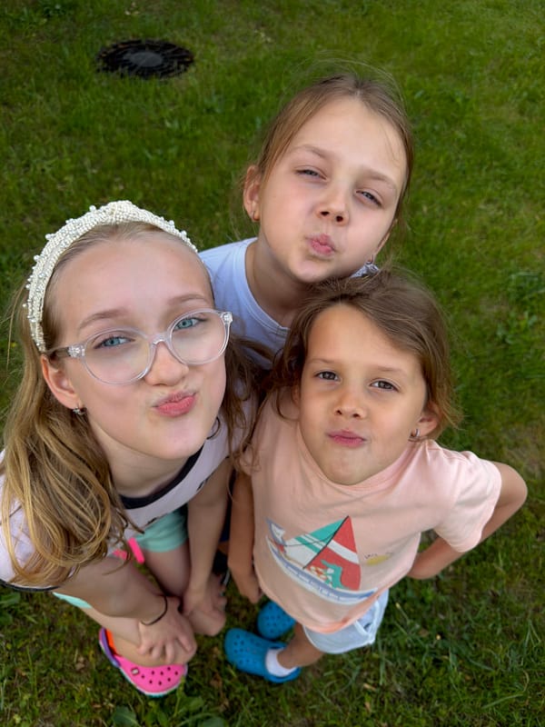 Girls blow kisses, tend garden in Dreiliņi afternoon
