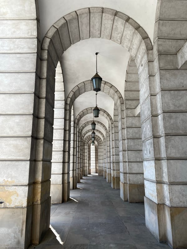 Arched stone colonnade in historic Warsaw