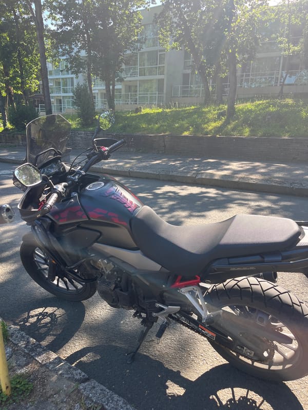 Motorcycle and outdoor dining scenes documented during sunny afternoon