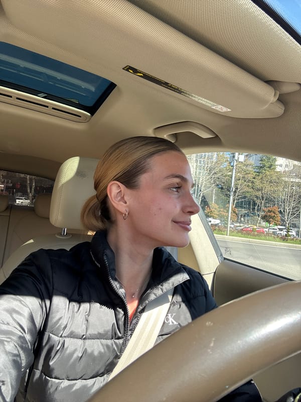 Woman in black jacket observed driving, walking in Tbilisi