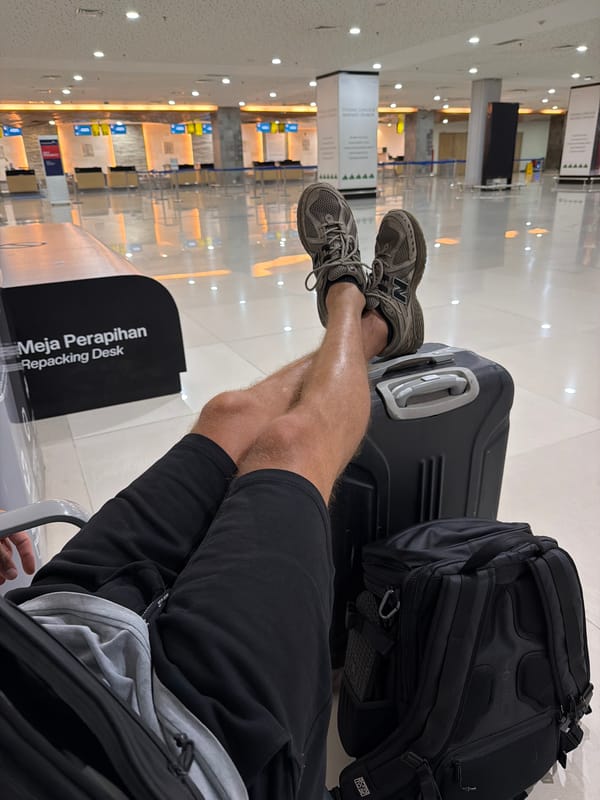 Traveler rests at Bali airport terminal