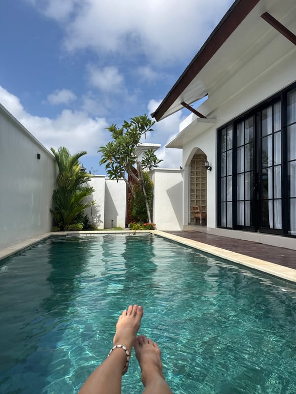 Feet in a turquoise pool, shell anklet, poolside relaxation