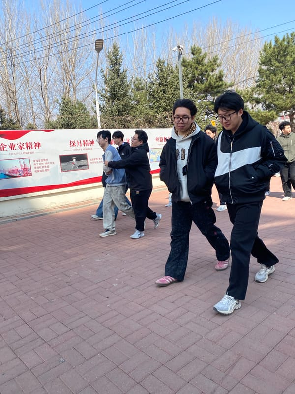 Group poses for photo near sign in Zhongtun