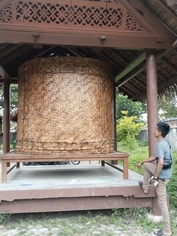 Museum visitor explores traditional Indonesian cultural exhibits in Lhokseumawe