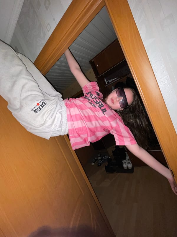 Young person photographed through wooden frame in Novoe Devyatkino