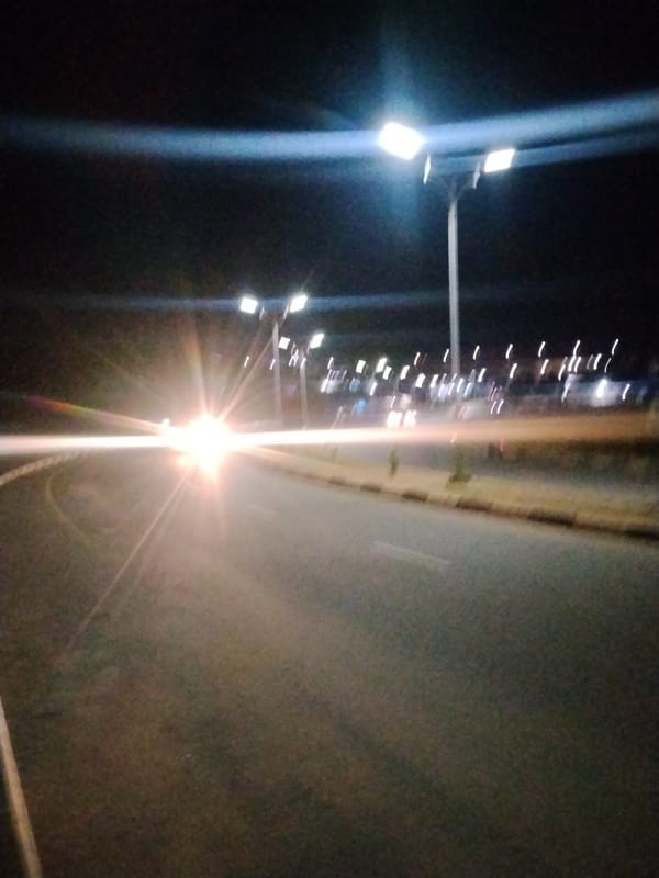 Suya stalls and streetlit roads on a Jos night