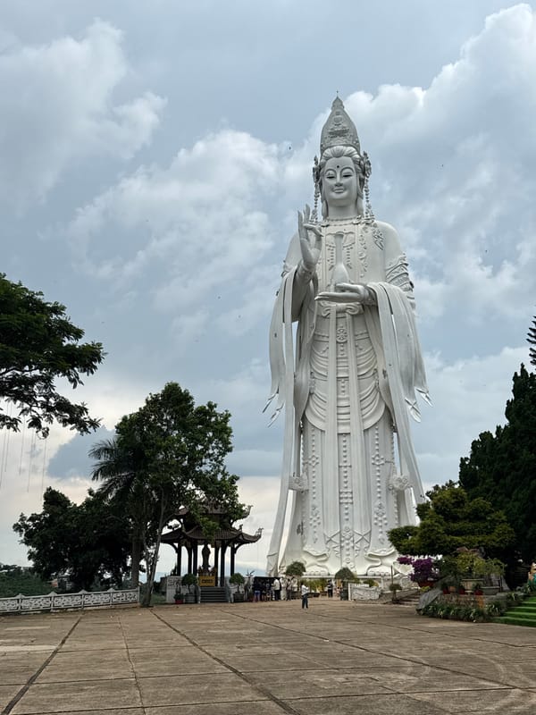 Buddhist statues and waterfalls at a Nam Ban spiritual site