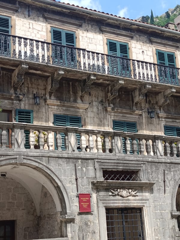 Browsing souvenirs and street scenes in Kotor's Old Town