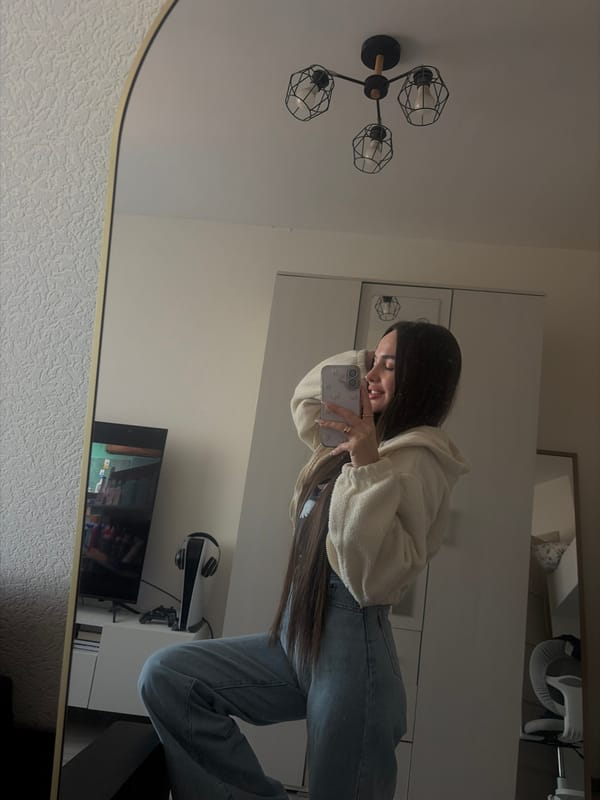 Woman takes mirror selfie in Saint Petersburg apartment