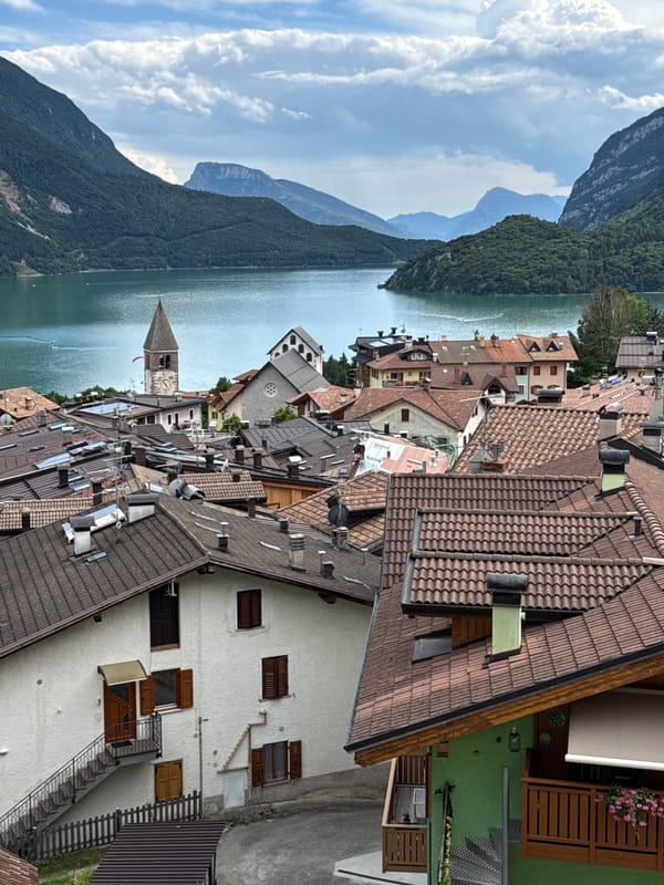 Molveno's flower-filled streets and mountain backdrop, mid-afternoon.