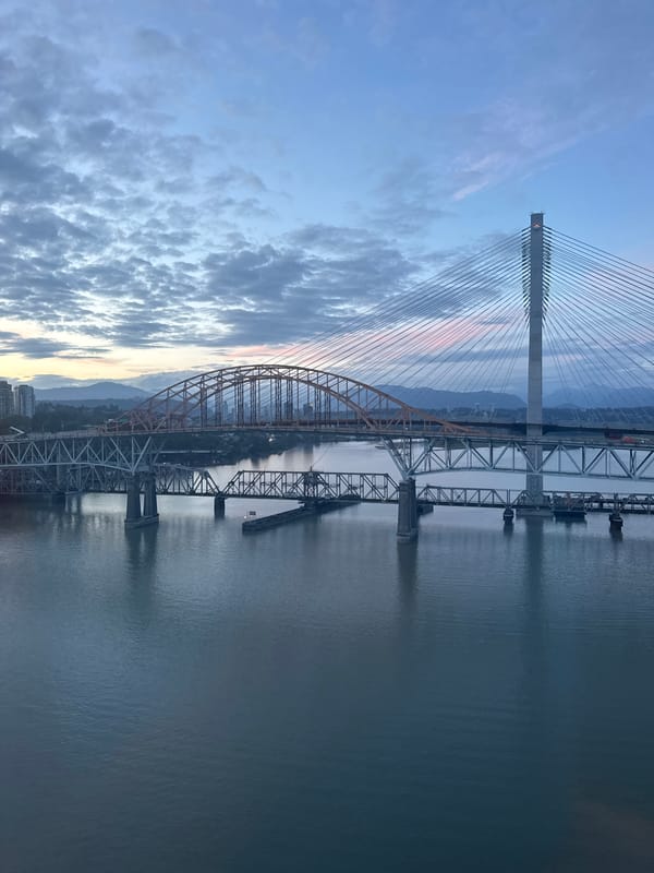 Fraser River at dawn, three bridges stretching across the water