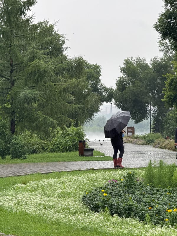 Rainy day stroll in Krasnoyarsk with coffee in hand