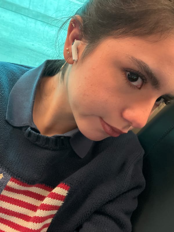 Woman with earbuds photographed from low angle in Chicago
