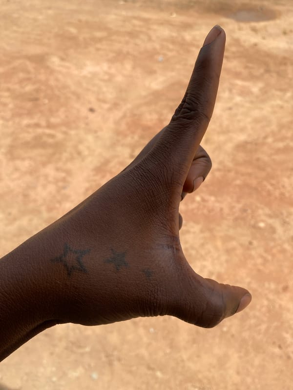 Hand gesture and skyward view documented in Rido, Nigeria