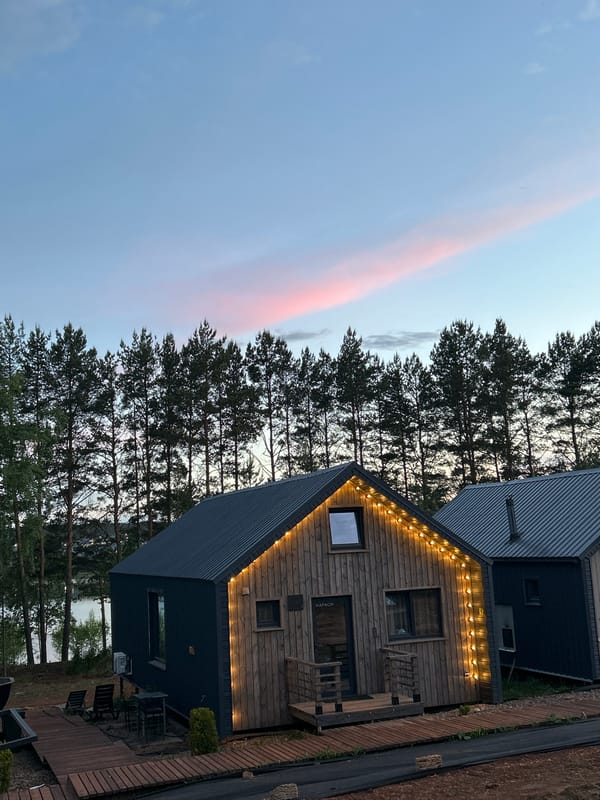 Wooden resort cabins observed at sunset in Pirogovo, Russia