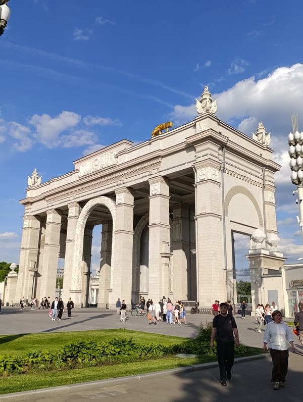 Visitor documents Moscow's classical archway and flowering public gardens