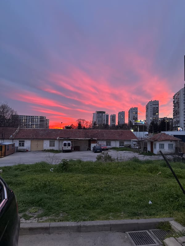 Dramatic pink-purple sunset illuminates Varna cityscape
