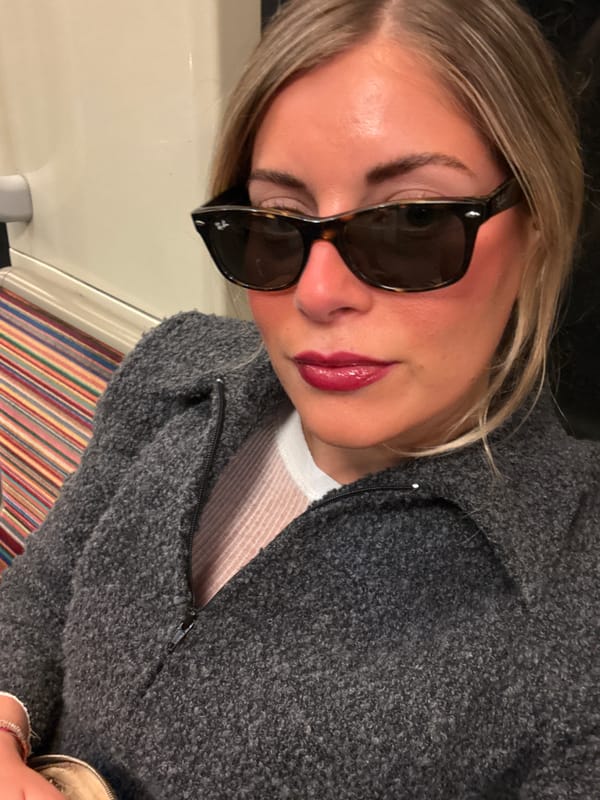 Blonde woman in sunglasses rides Paris metro Saturday evening