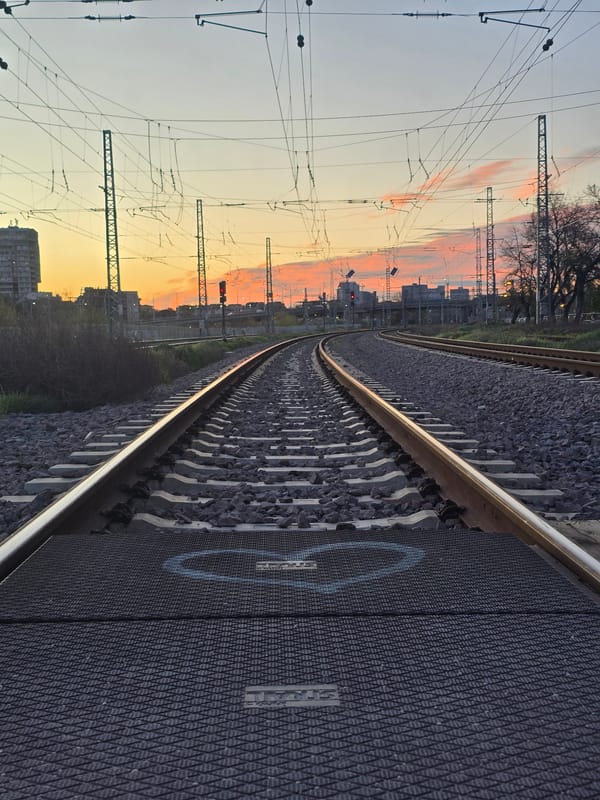Train approaches through urban Plovdiv at dawn