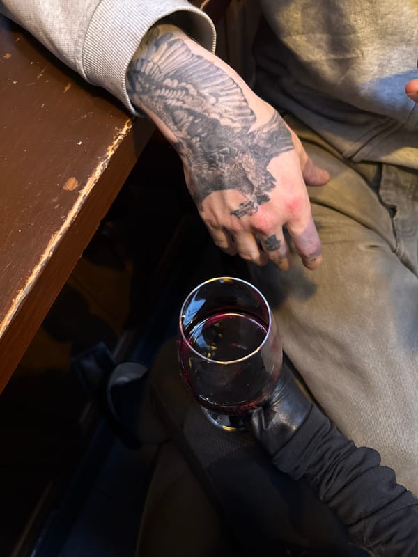 Two people meet at Edinburgh venue, bird tattoo visible