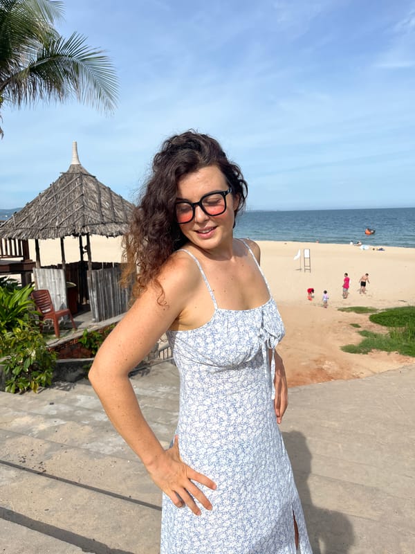 Posing through Mũi Né's coastal garden installations, blue dress throughout