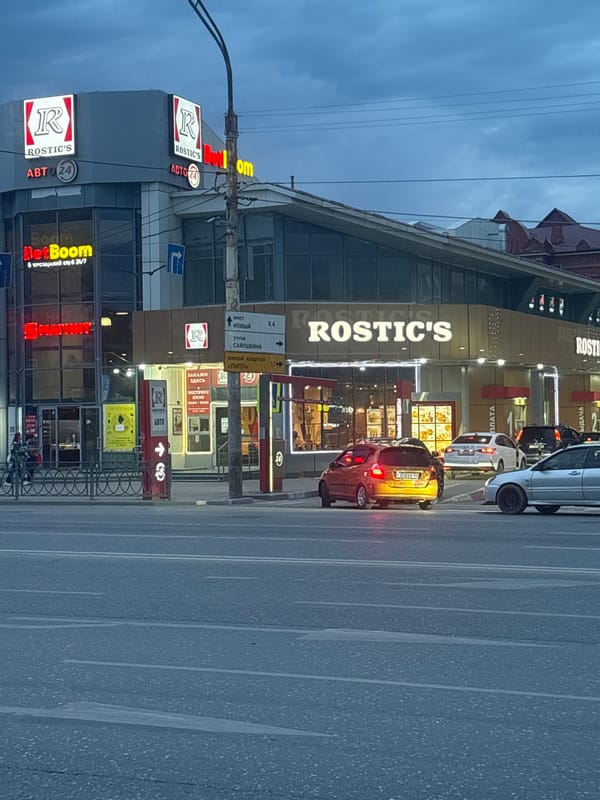 Evening street life documented across central Astrakhan under overcast skies
