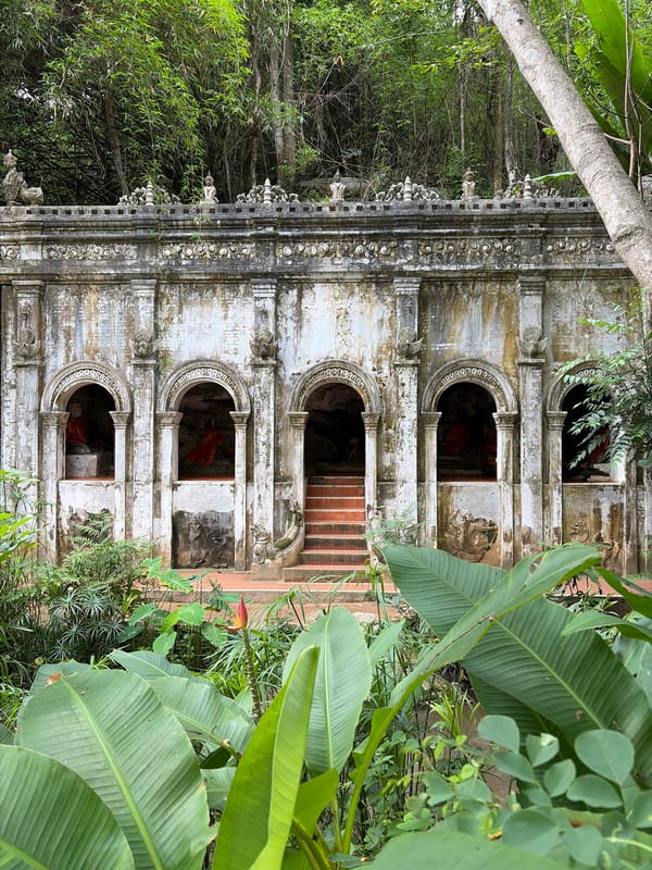 Ancient jungle-edged temple with Buddha alcoves, Suthep hillside