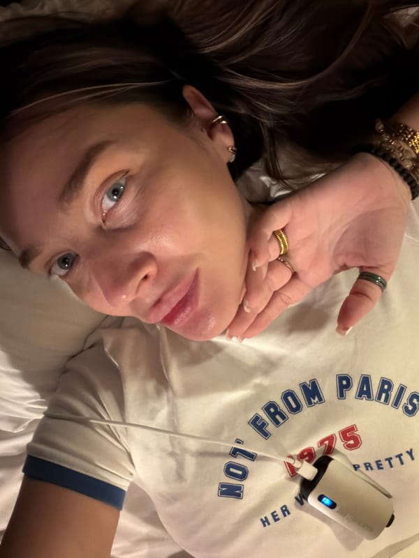 Woman in white t-shirt photographed on bed in Moscow