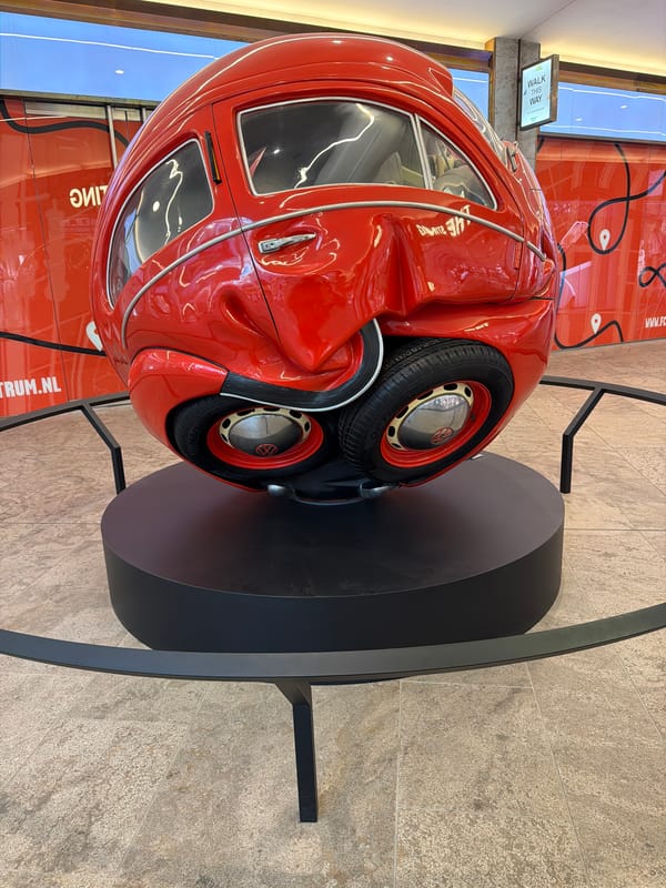 Spherical Beetle sculpture and tulips documented in Amsterdam