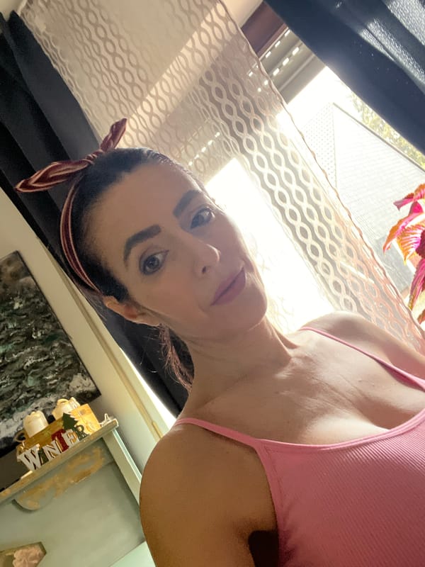 Woman in pink tank top observed by window in Konz