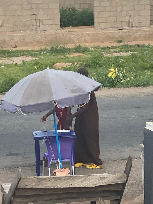 Street life and social media screens blend in Jalingo, Nigeria