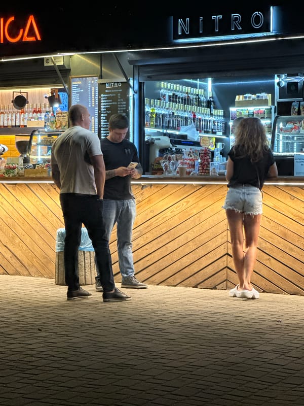 Summer evening at Odesa's lit-up outdoor kiosk strip
