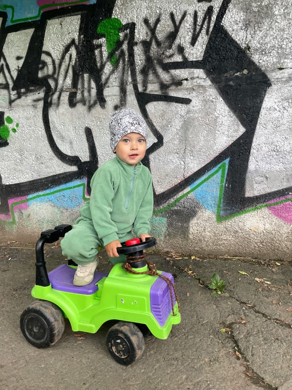 Toddler takes a toy car out for a spin in Izhevsk