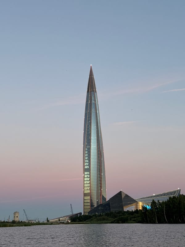Fishing at dusk with Lakhta Center glowing on the horizon
