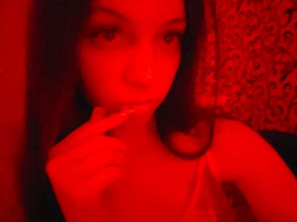 Red-lit room in Chystiakove, close-up self-portraits at night.