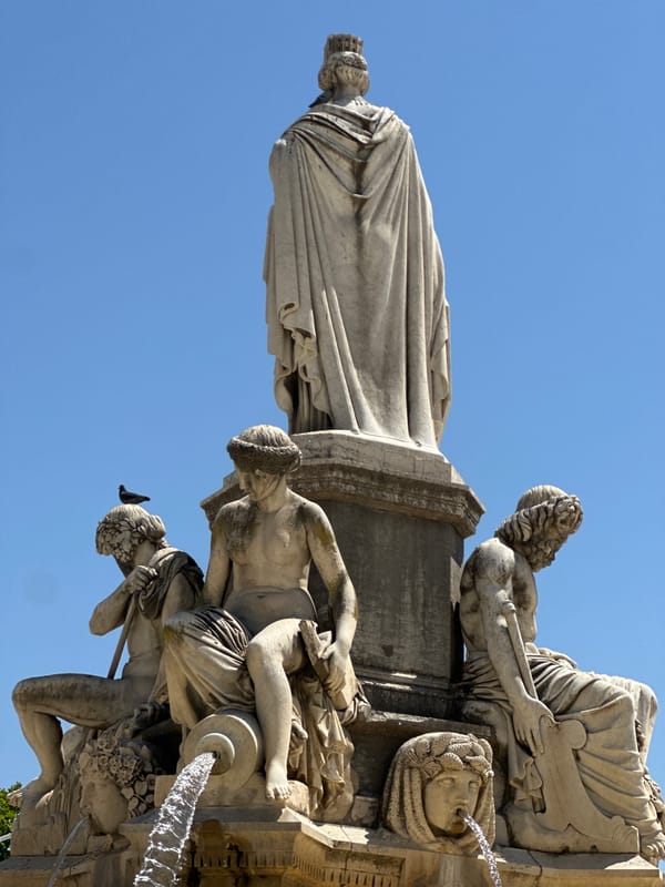 Pride parade and fountain square scenes in sunny Nîmes