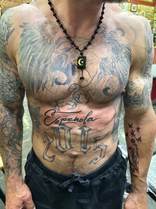Heavily tattooed individual photographed indoors in Moscow