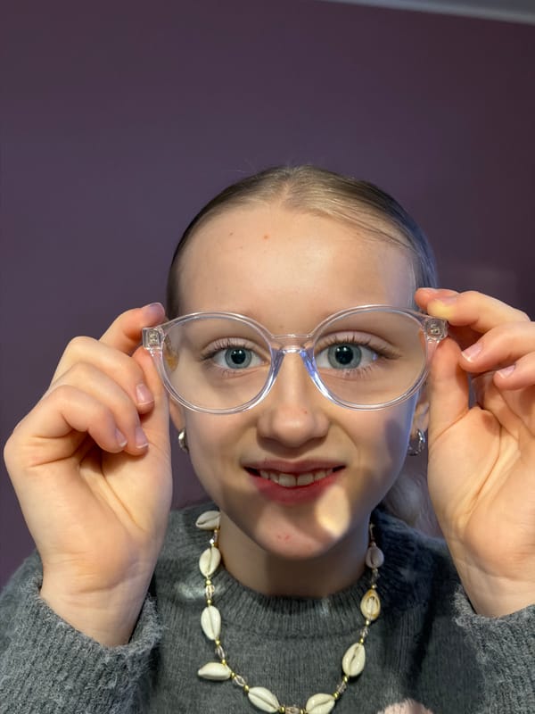 Woman tries on glasses in Dreiliņi
