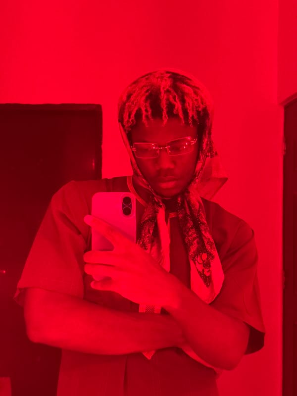 Person takes red-lit selfies indoors in Igboefon, Nigeria