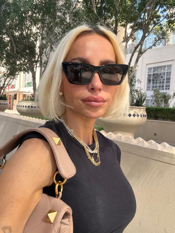 Woman takes selfie in Dubai wearing sunglasses and jewelry