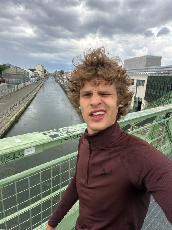 Young person takes cheerful selfie on Milan bridge