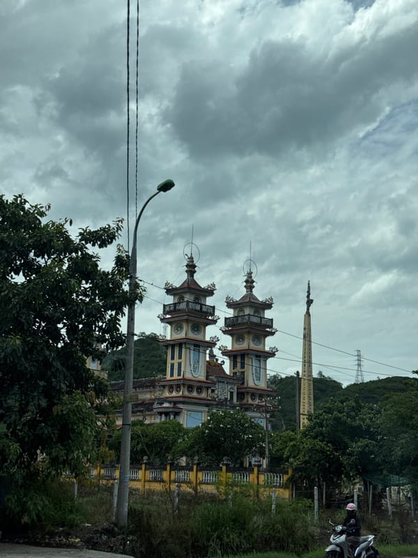 Driving past a temple on Highway QL1, Vĩnh Lương