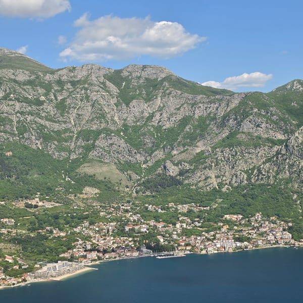 Aerial views capture coastal town Strp, Montenegro's scenic mountainside setting