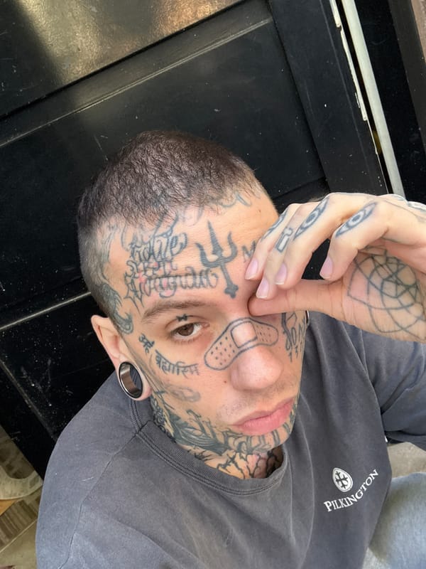 Heavily tattooed person photographed in close-up portrait in Buenos Aires