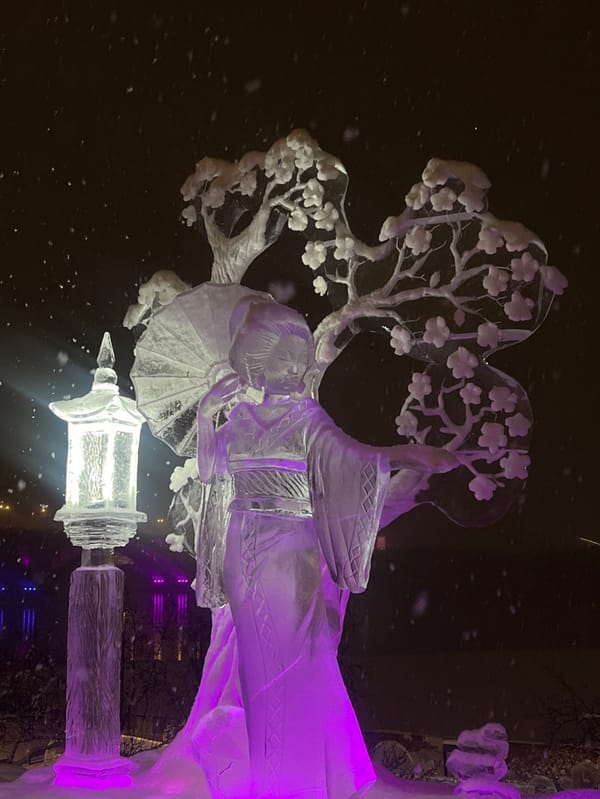 Winter festival with ice sculptures observed during snowfall in Krasnoyarsk