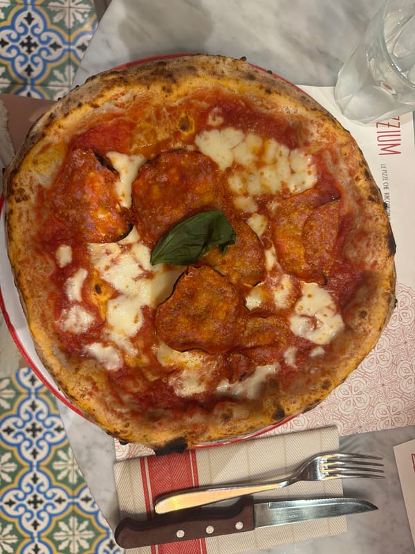 Overhead close-up of a charred-crust pepperoni pizza in Milan
