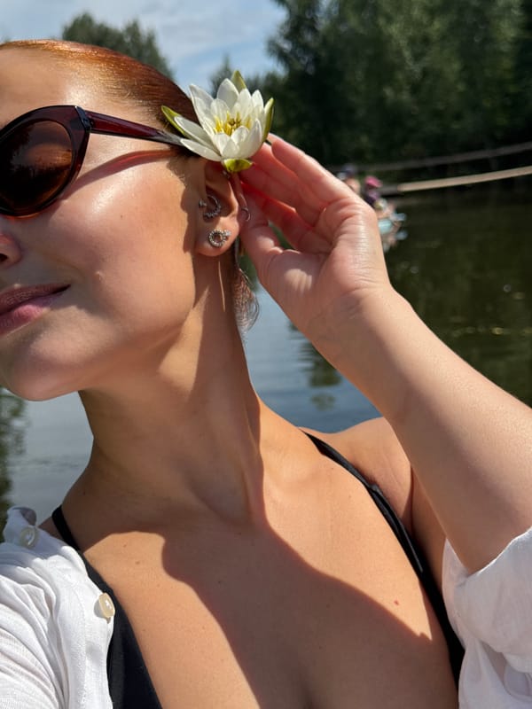 Paddleboarding with a white flower on a Russian lake