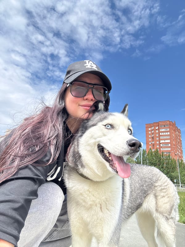 Woman and Siberian Husky photographed during sunny urban outing